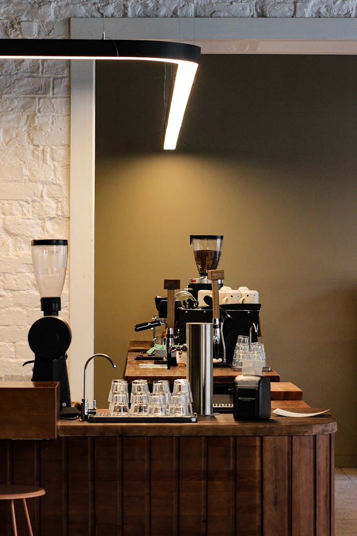 services-02 Stylish cafe interior in Saint Petersburg, featuring espresso machines and a minimalist design.